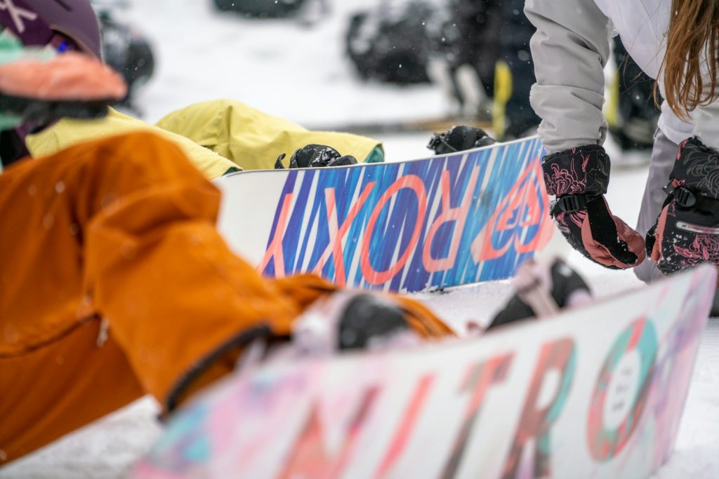 a person holding a snowboard on a snowy surface